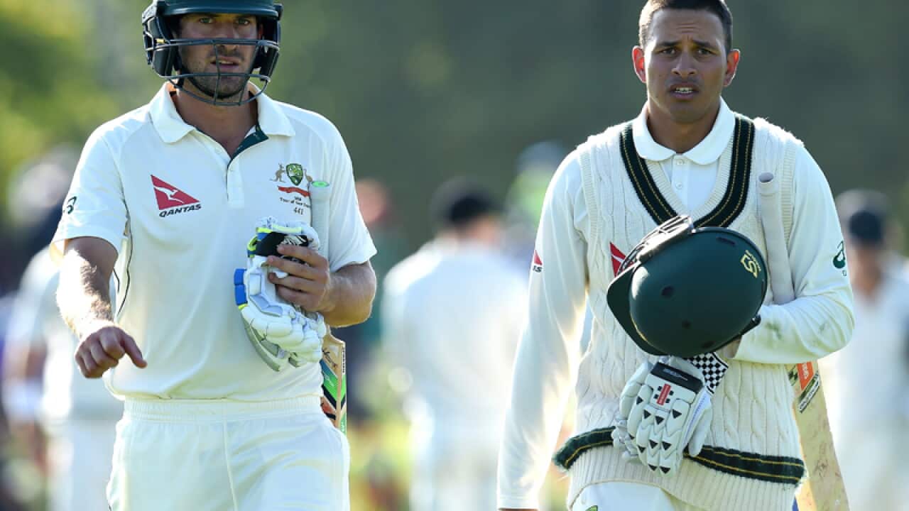 Australian batsmen Joe Burns (L) and Usman Khawaja