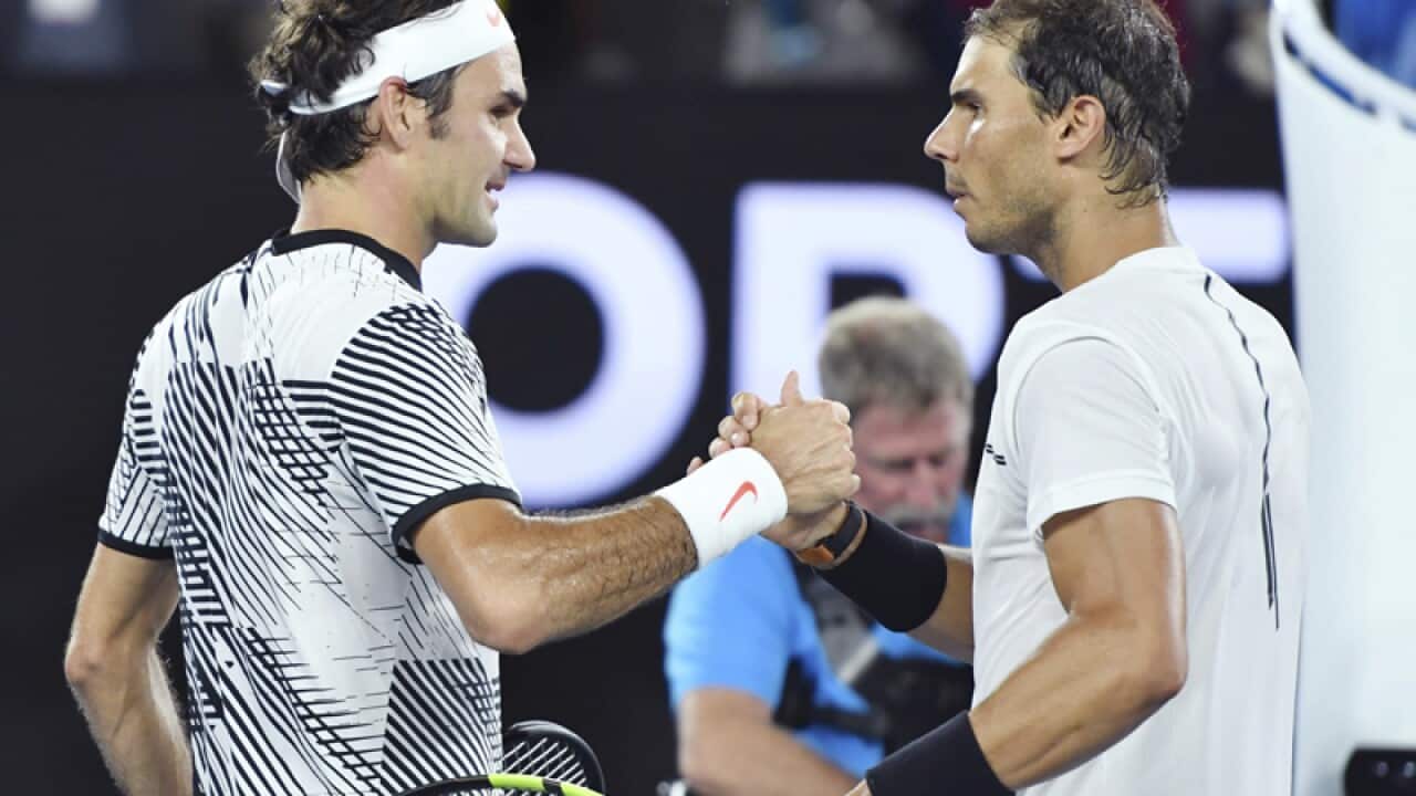 Roger Federer (L) shakes hands with Rafael Nadal