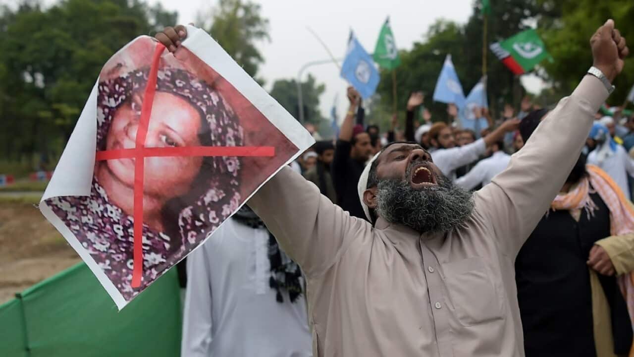 A Pakistani supporter of a hardline religious party, holds an image of Christian woman Asia Bibi during a protest rally.