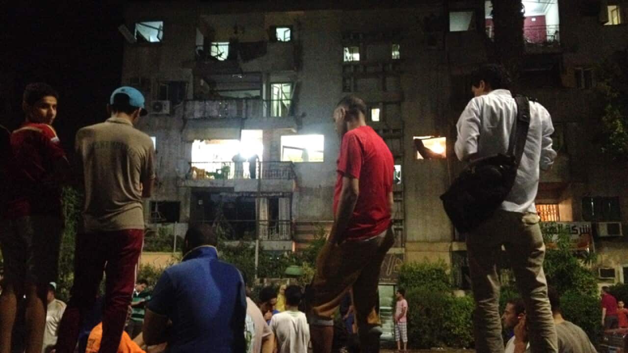 People gather at the scene of a bomb blast in Cairo