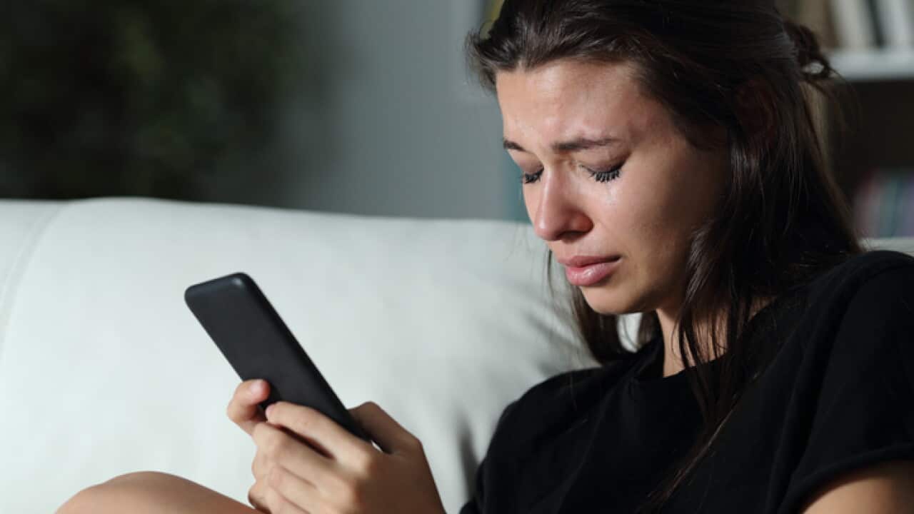 Sad teen crying after read phone message