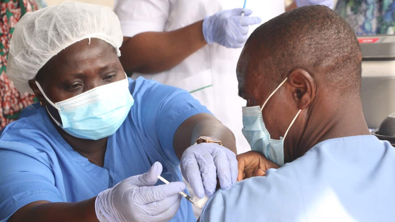 A health worker administers a COVID-19 vaccine in Nigeria.
