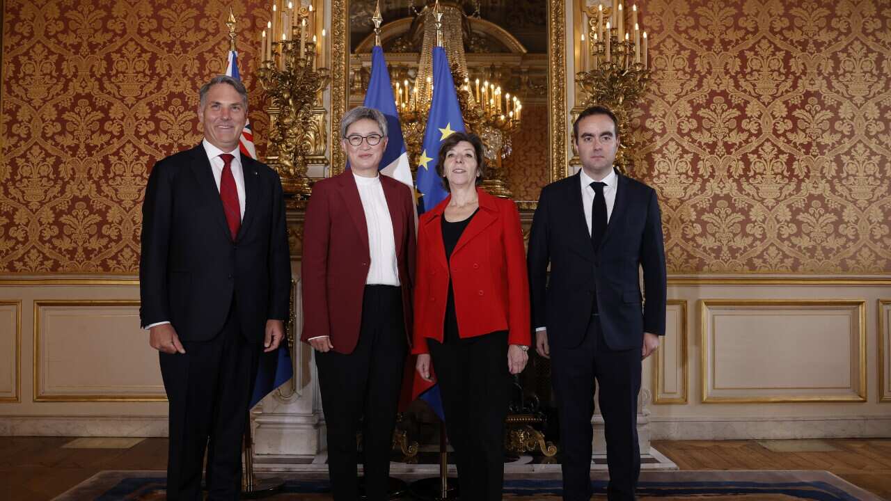 Four people standing together in a palace.