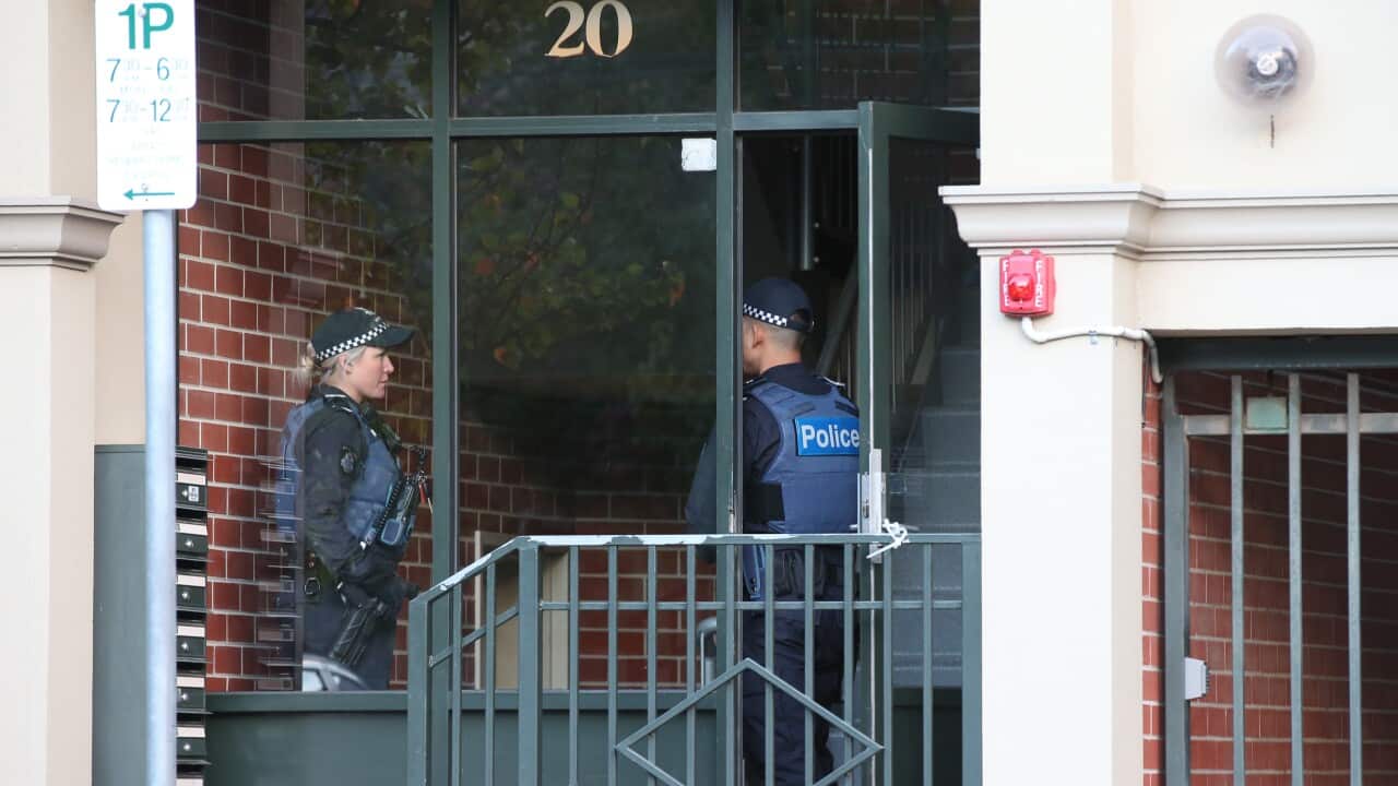Police are seen at an address in North Melbourne.