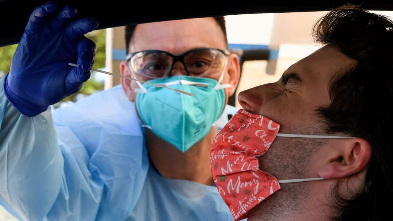A man receives a COVID-19 test at the St Vincent’s Hospital drive-through testing clinic at Bondi Beach in Sydney