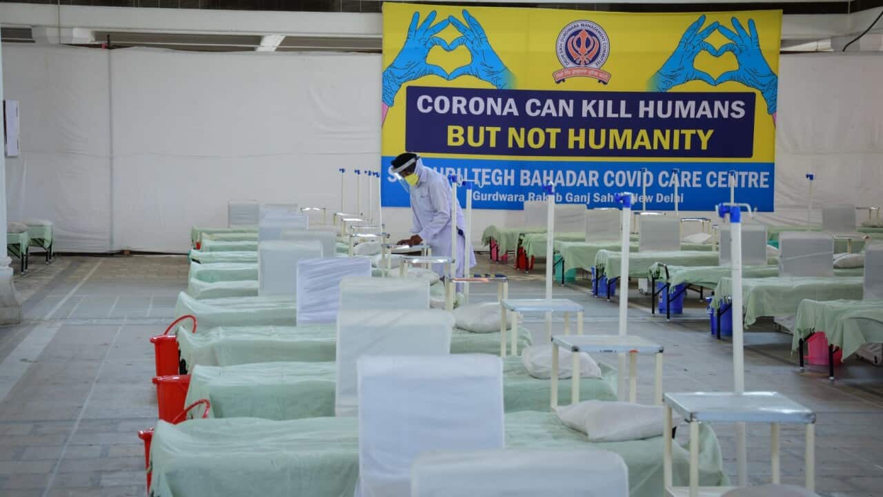 A volunteer prepares beds inside the Covid care facility for patients suffering from the coronavirus disease (COVID-19), amidst the rising number of the coronavirus cases at Rakab Ganj Gurudwara in New Delhi.