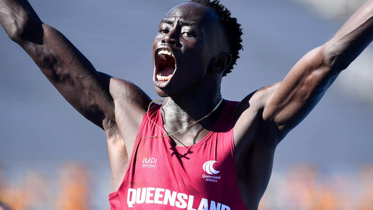 Gout Gout raising his arms after winning the U18s, 100m final during the Australian All Schools Athletics Championships