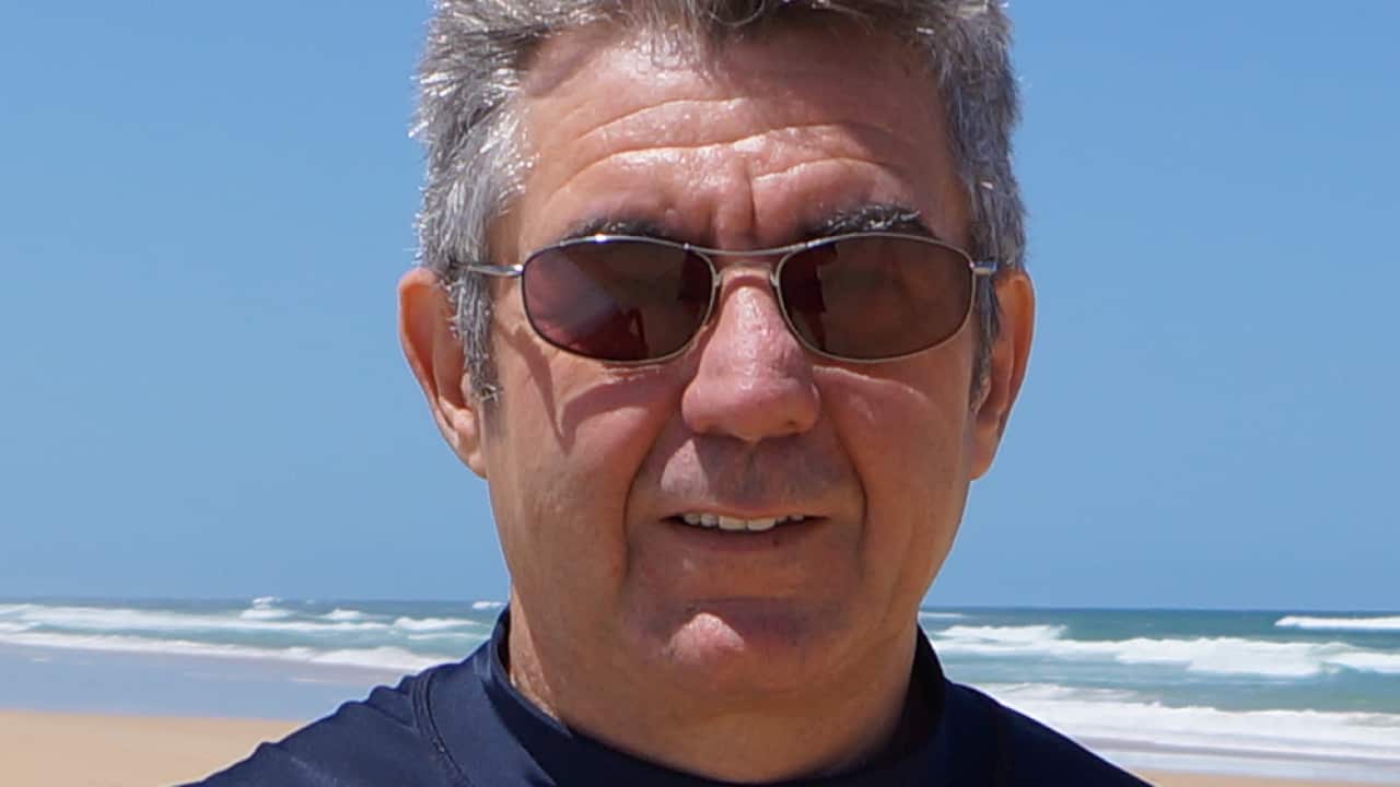 A middle-aged man on a beach