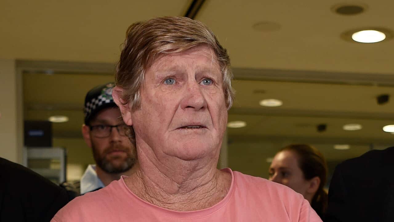 John Bowie is seen arriving via police escort at Sydney Domestic Airport in 2019.