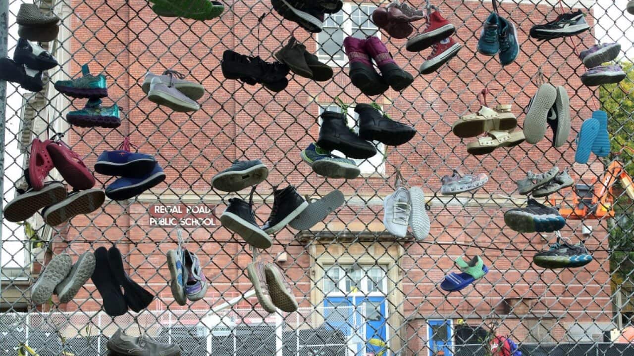 A school marks National Day of Truth and Reconciliatio in the form of shoes tied to a fence near Davenport, Canada.