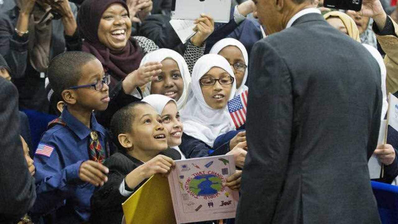 President Barack Obama stops to greets children from Al-Rahmah school and other guests during his visit to the Islamic Society of Baltimore.