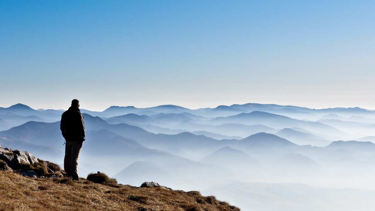 Misty mountain hills and silhouette of a man