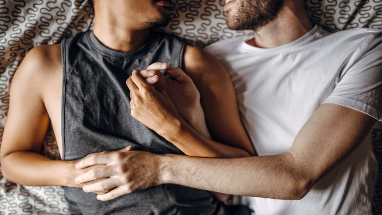 Loving gay couple in bed