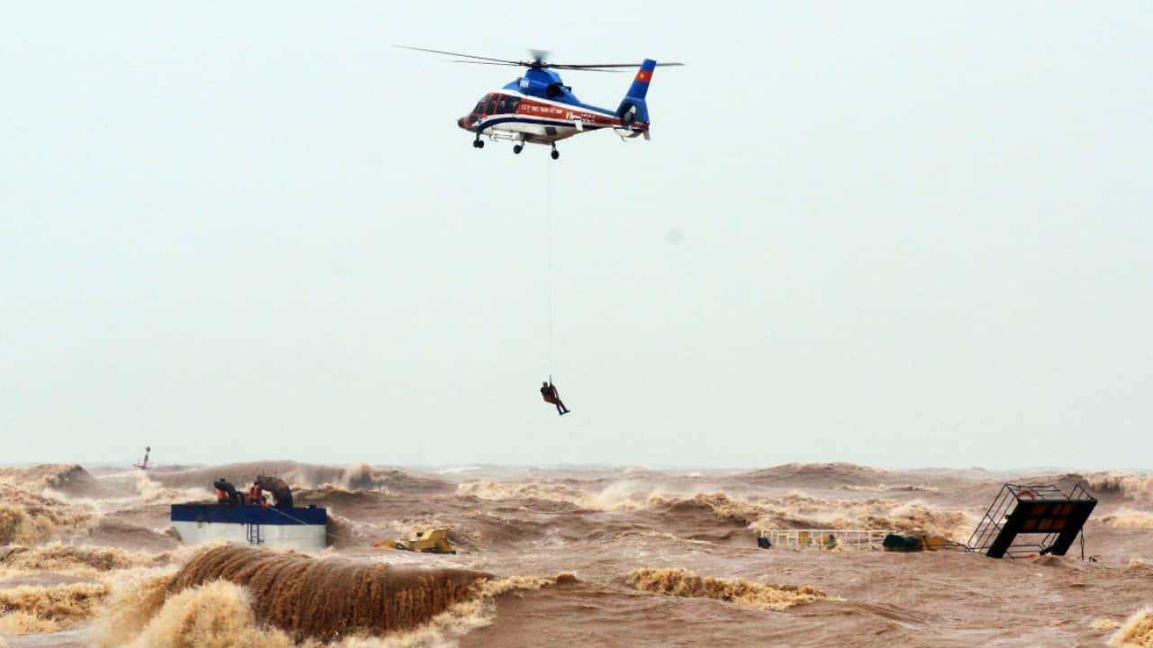 A helicopter from Ministry of Defence rescue stranded crew members at the sea, in Quang Tri province, Vietnam, 11 October 2020.