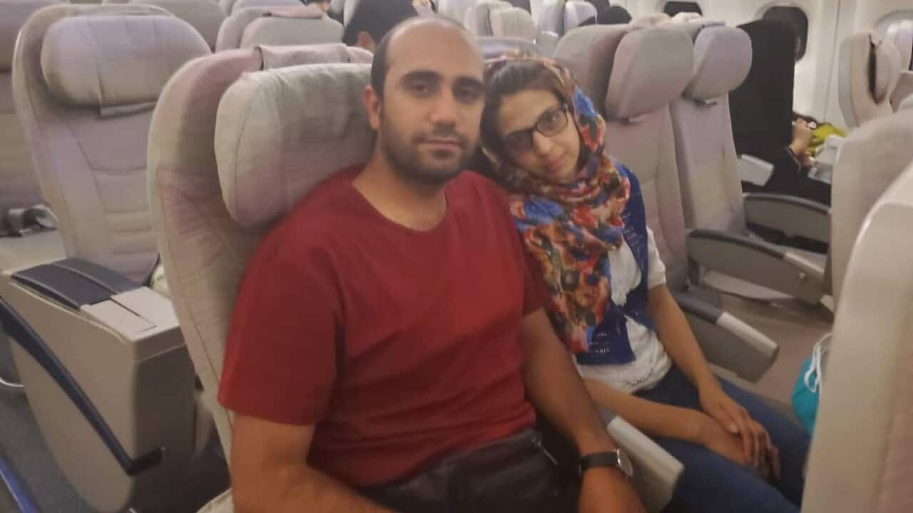Afghan man and former ADF translator Fahim and his wife on a flight to Perth.