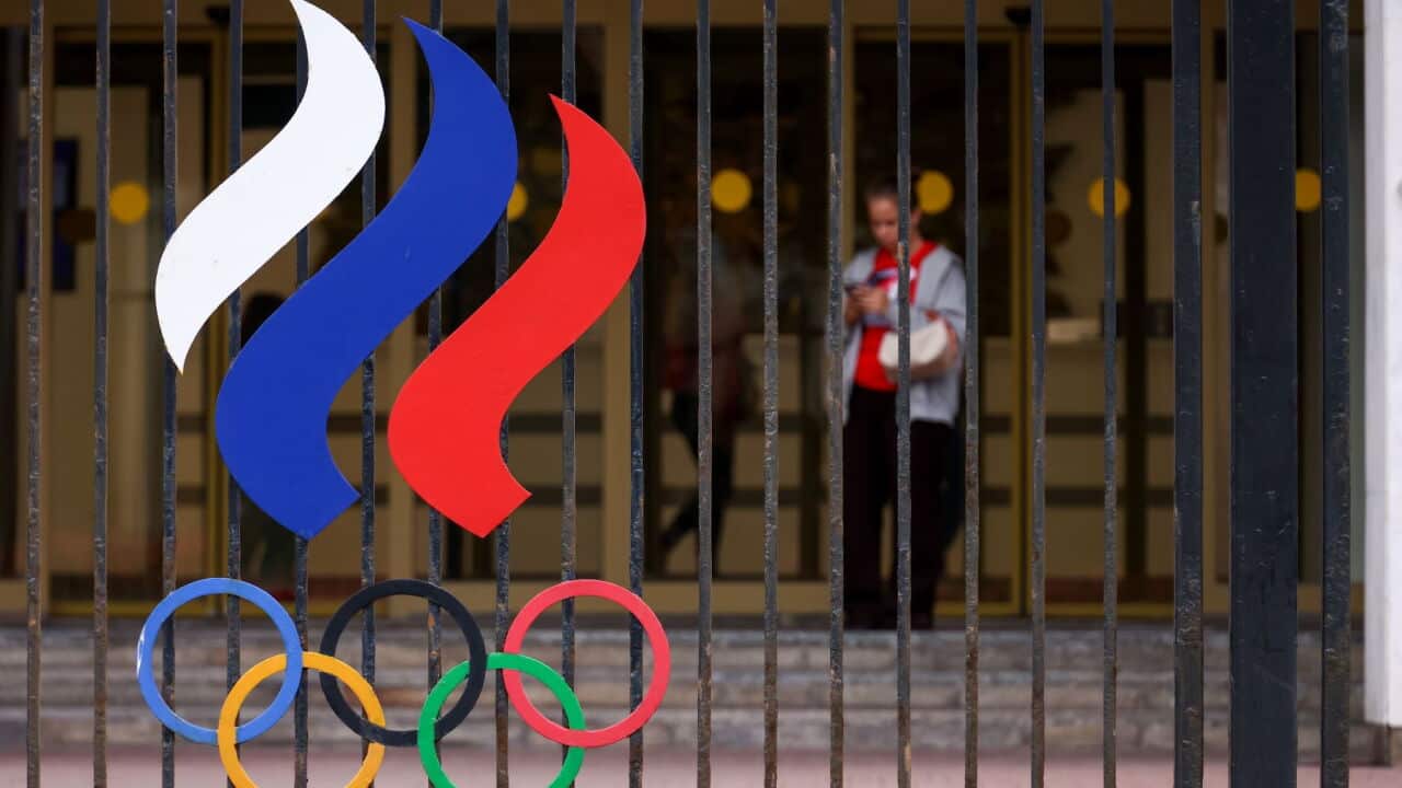 A woman emerges from the Russian Olympic Committee building on Luzhnetskaya Embankment, Khamovniki, central Moscow (Artyom Geodakyan-TASS-Sipa USA).jpg