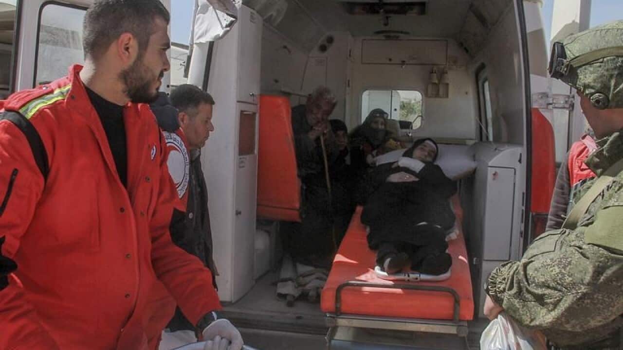Handout photo of Syrian Red Crescent and Red Cross helping civilians.