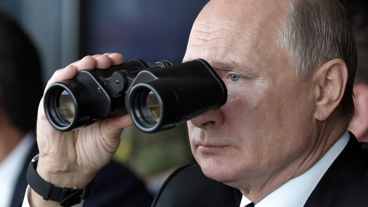 A man looking through binoculars