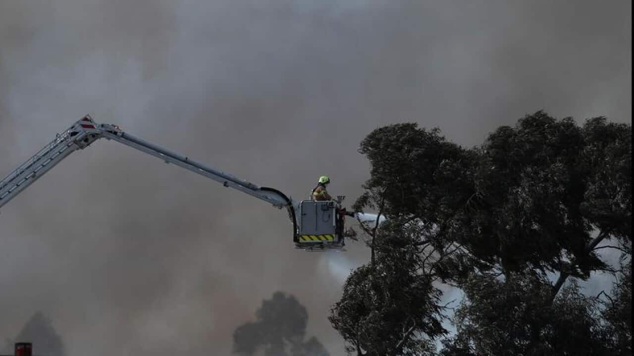 Fire crews work out to put out a huge fire at a recycling centre