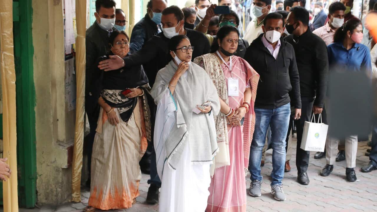 West Bengal Chief Minister Mamata Banerjee (white) with her sister-in-law Kajari Banerjee (pink) during Municipal corporation Election in Kolkata on 19 Dec 2021