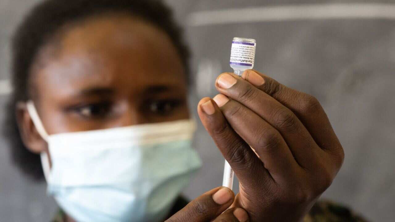 A nurse draws a dose of the Pfizer Coronavirus vaccine on 29 September, 2021 in Kampala, Uganda.