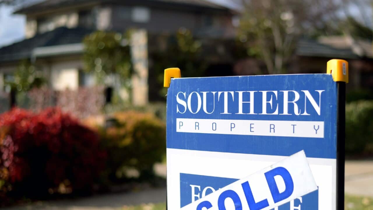 A sale sign is seen in front of a house in Canberra