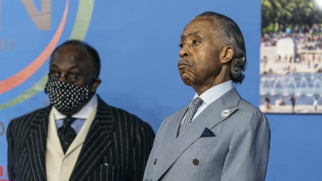 Reverend Al Sharpton (R) speaks against the rise of attacks against Asian Americans