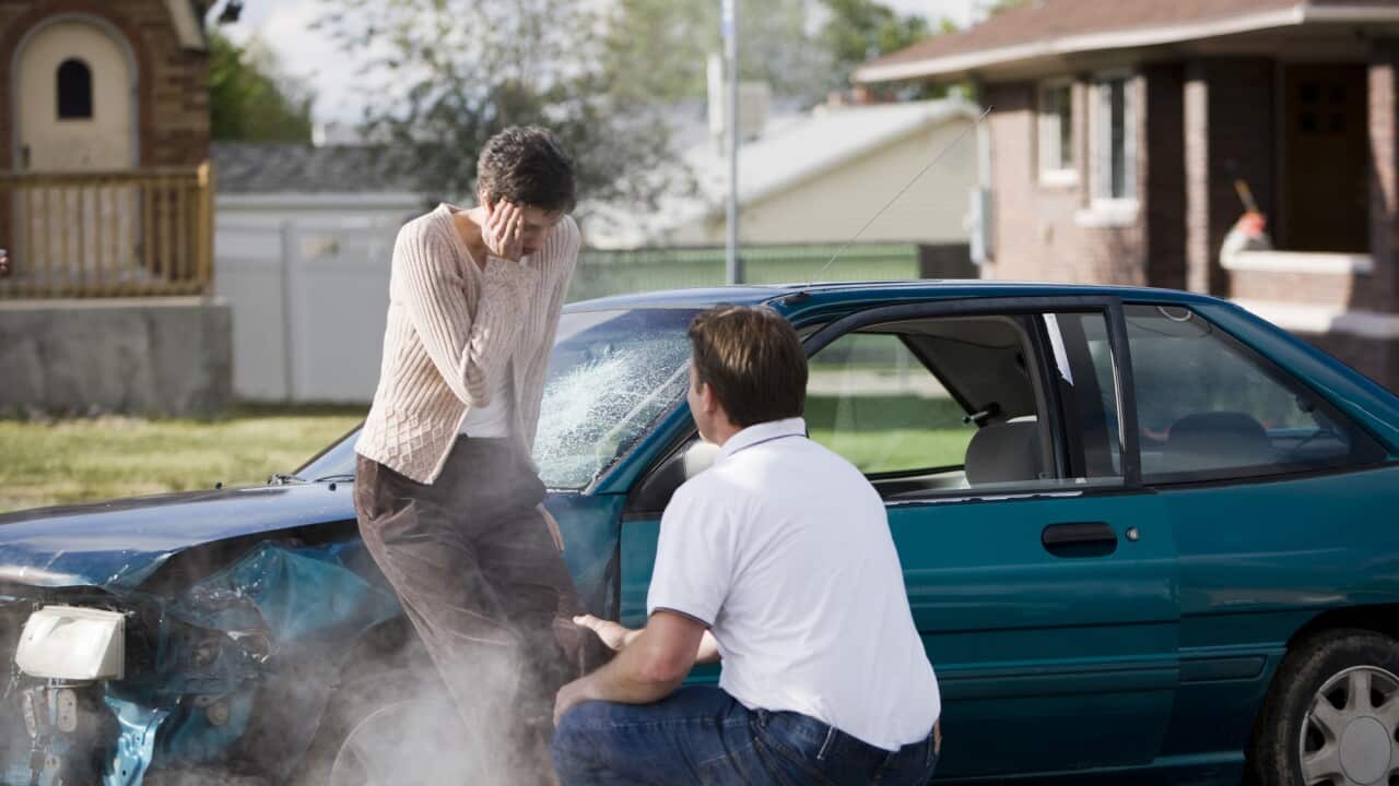 man helping a woman after a car accident