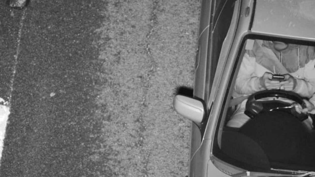 This driver was caught texting while the passenger took the wheel.