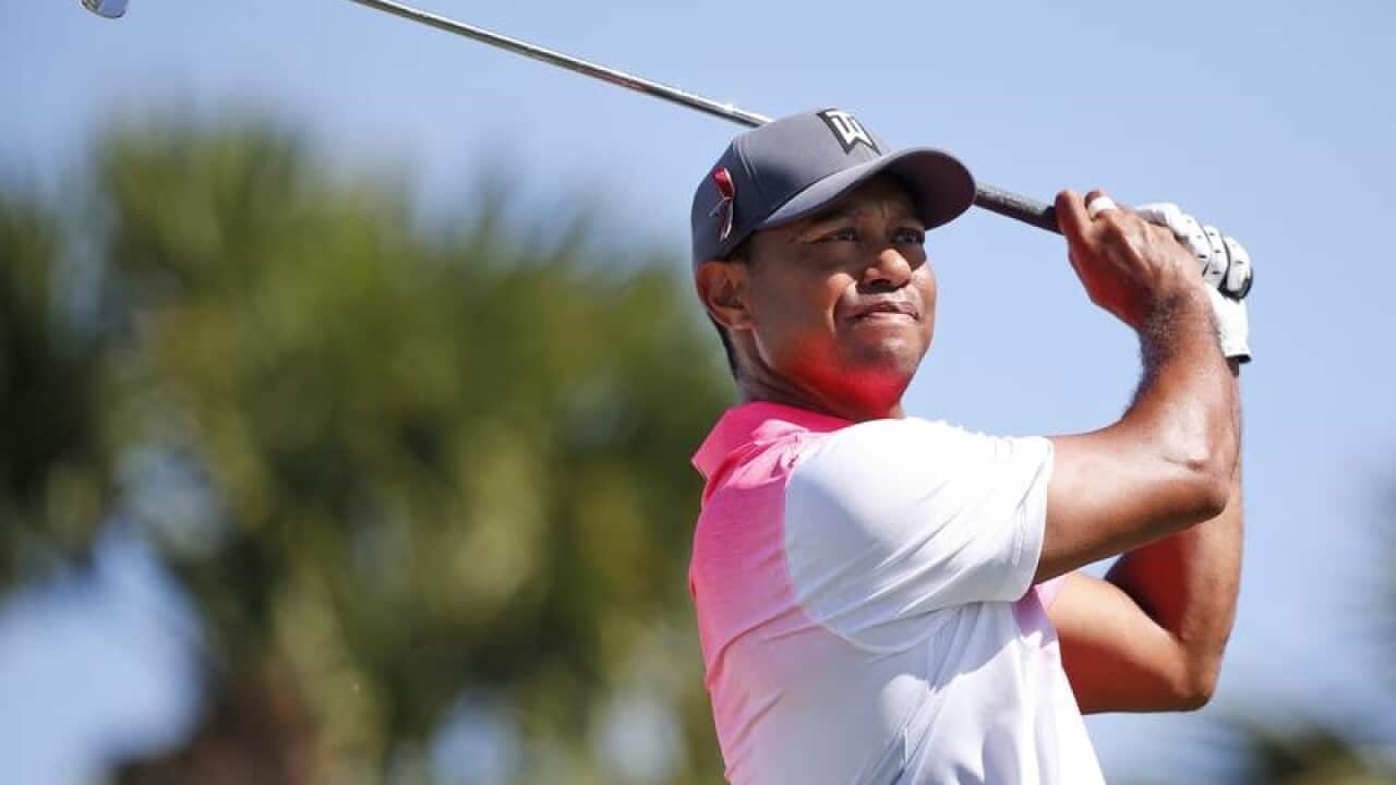 Tiger Woods tees off