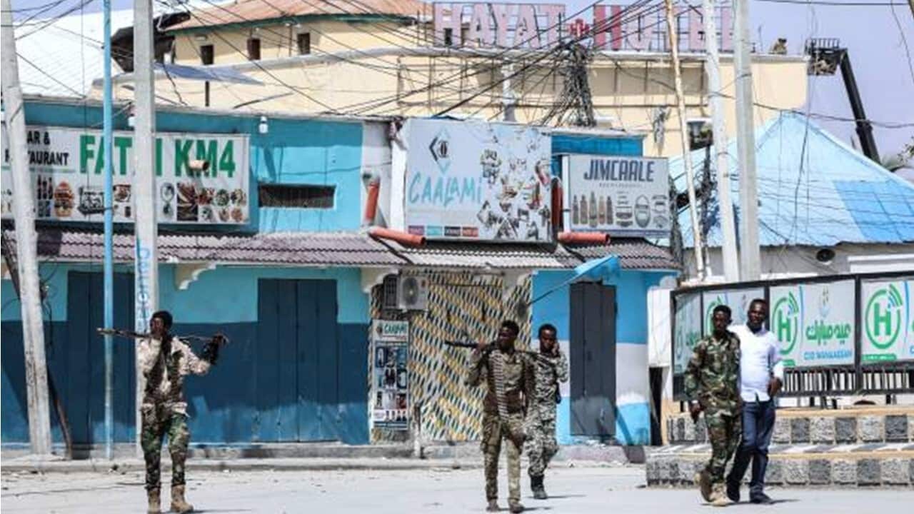 Security officers patrol near the the site of explosions in Mogadishu.jpg