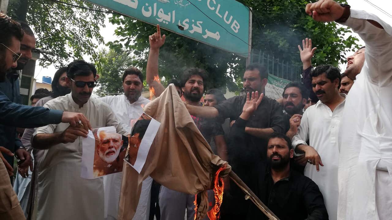 Pakistani protesters burn an effigy of Indian Prime Minister Narendra Modi 