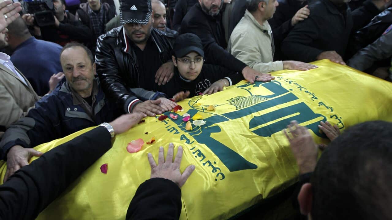 Hezbollah members and relatives mourn over the coffin of Samir al-Qantar, a Lebanese Hezbollah militant who was assassinated a day earlier in an Israeli airstrike in Syria