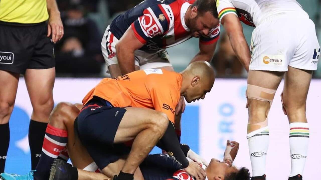 Latrell Mitchell receives attention against the Panthers.