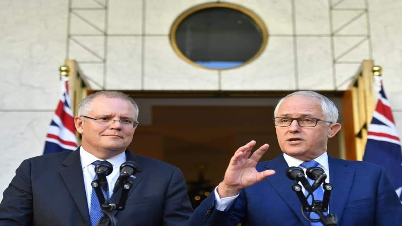 Scott Morrison (left) and Malcolm Turnbull with flags in background