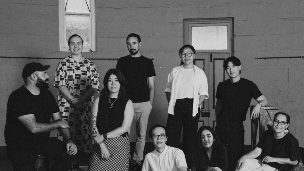 The Neighbour at the Gate exhibition artists and curatorium, left to right: Dennis Golding, Zali Morgan, Jenna Lee, James Tylor, James Nguyen, Jacky Cheng, Elham Eshraghian-Haakansson, Micheal Do, Clothilde Bullen OAM; National Art School, 2025, image courtesy and © National Art School, photograph: Peter Morgan
