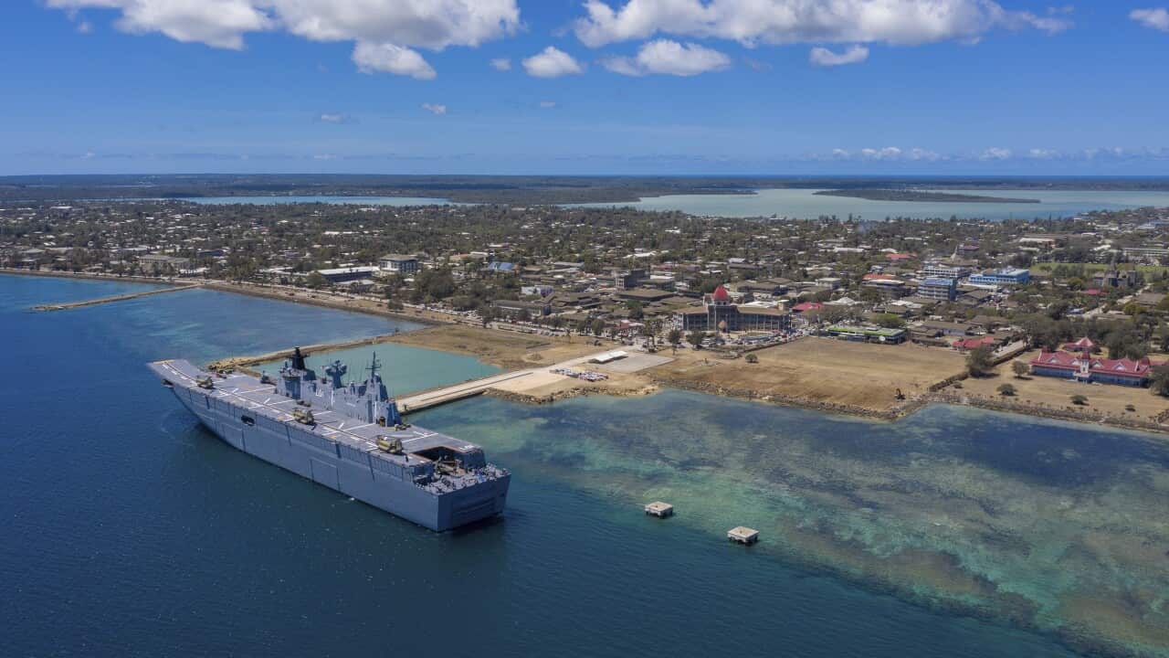 Ship docks in ocean near island port