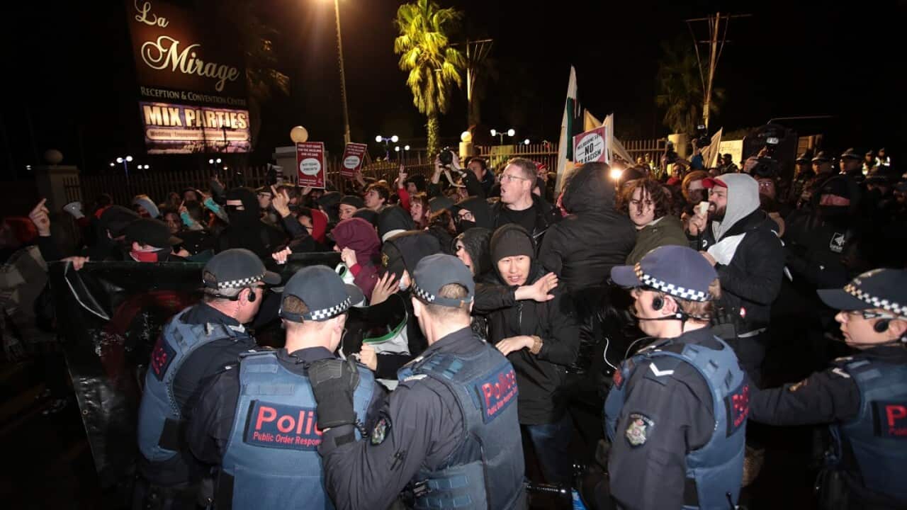 Protesters are forced back by police after attempting to stop a bus full of people arriving to hear Lauren Southern.