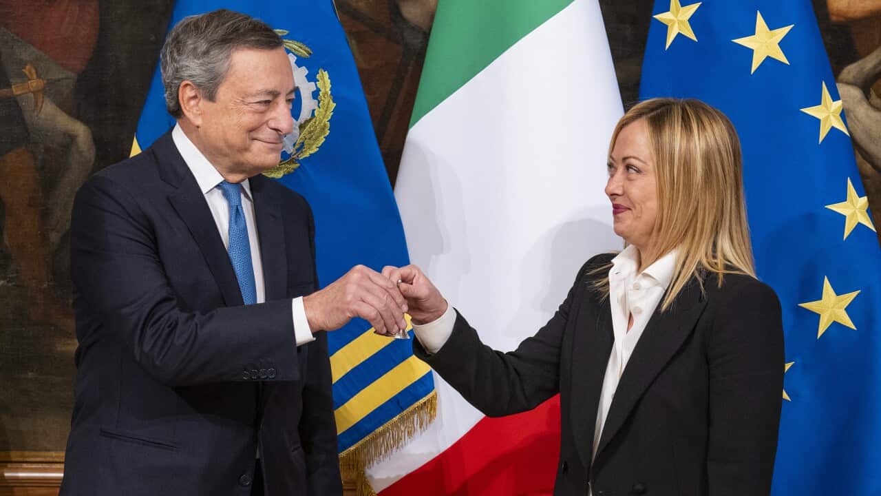 Italy's newly appointed Prime Minister Giorgia Meloni receives a little silver bell from former Prime Minister Mario Draghi during the 'Bell Ceremony' at Palazzo Chigi in Rome.