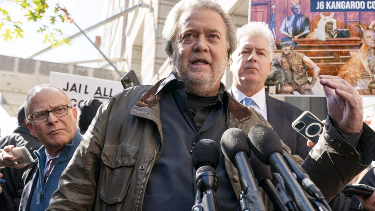 Steve Bannon (centre) and his lawyer Evan Corcoran (right) speak to reporters as he leaves the federal courthouse on 21 October 2022.