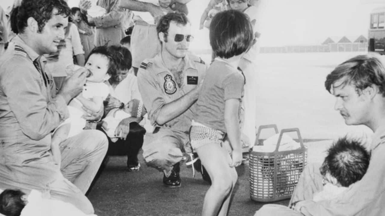 Image of RAAF officers caring for children ahead of Operation Babylift flight (Image supplied - RAAF).jpg