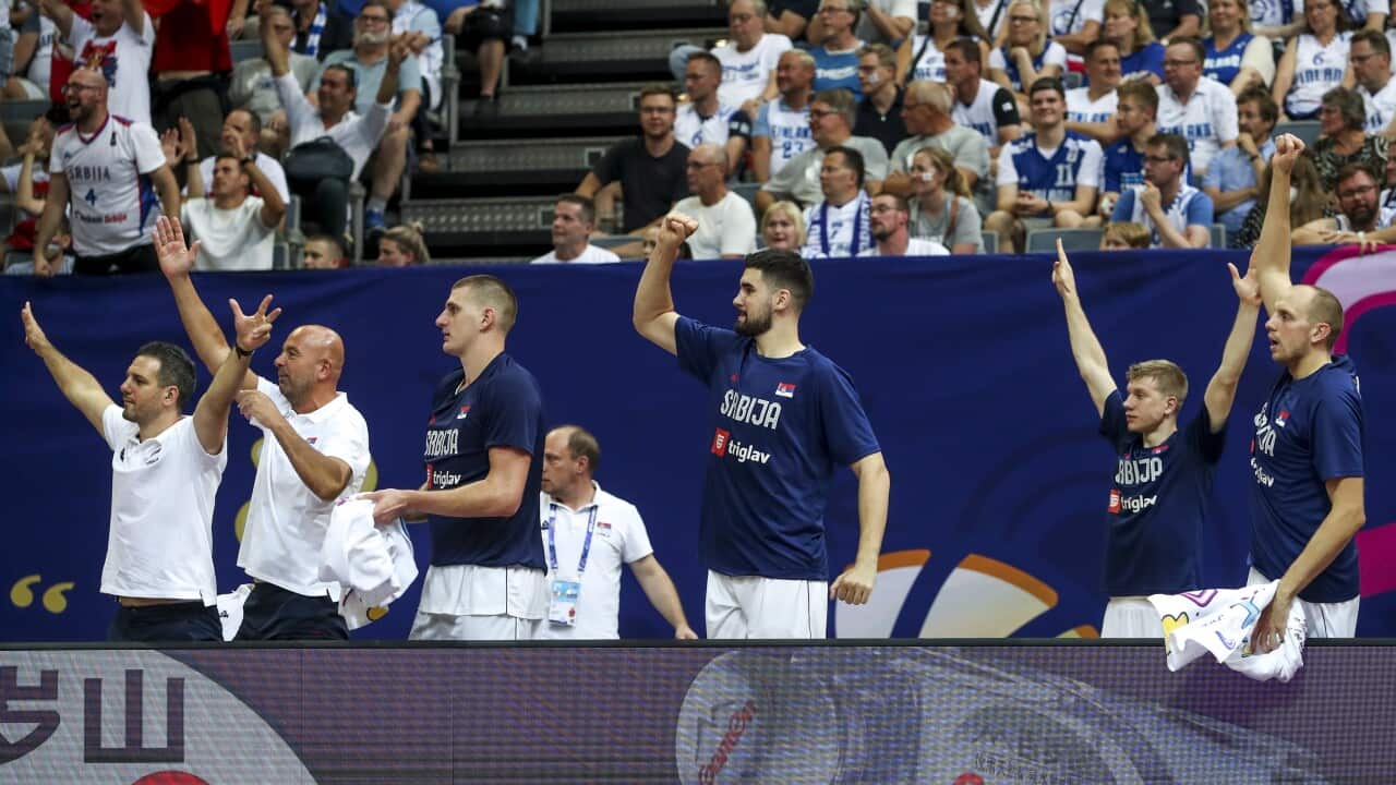 Players of Serbia's basketball team celebrate on the bench during FIBA EuroBasket 2022 group stage match against Finland in Prague
