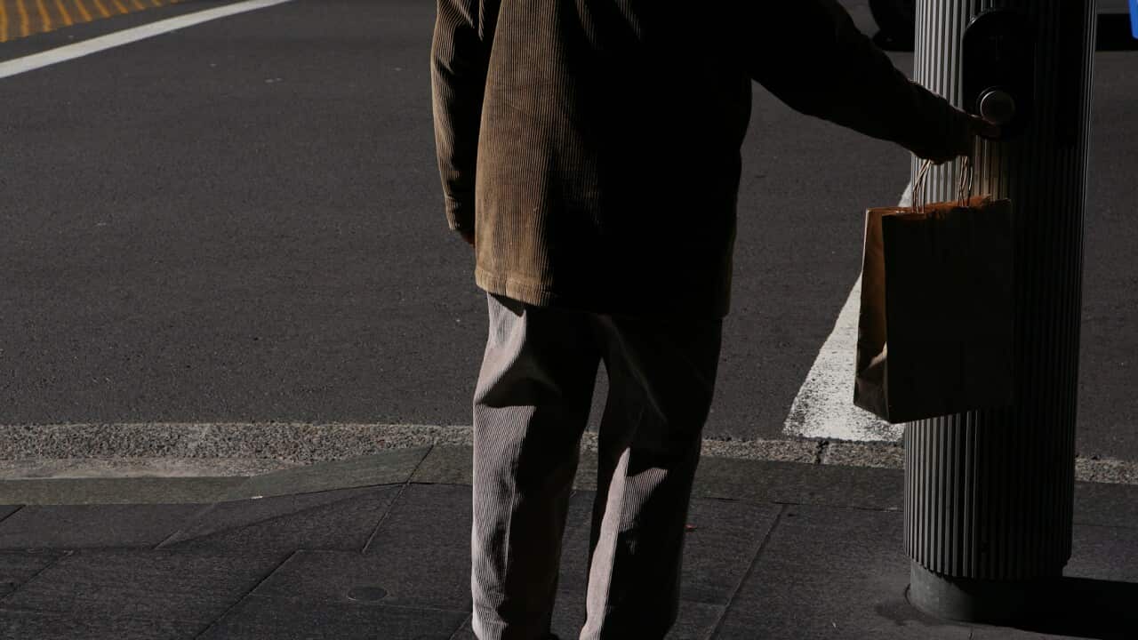 An elderly man waits at traffic lights on George Street in Sydney, Wednesday, May 18, 2011. (AAP Image/Angela Brkic) NO ARCHIVING