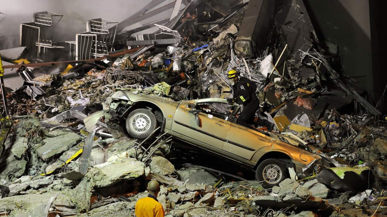 Rescue workers search for victims buried under the rubble near the Canterbury Television building in Christchurch, 22 February 2011