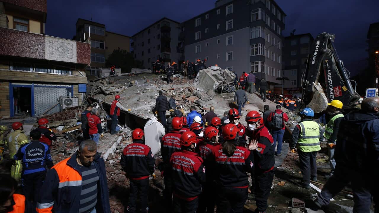 Rescue workers work on the rubble of an eight-story building which collapsed in Istanbul, Wednesday, Feb. 6, 2019.