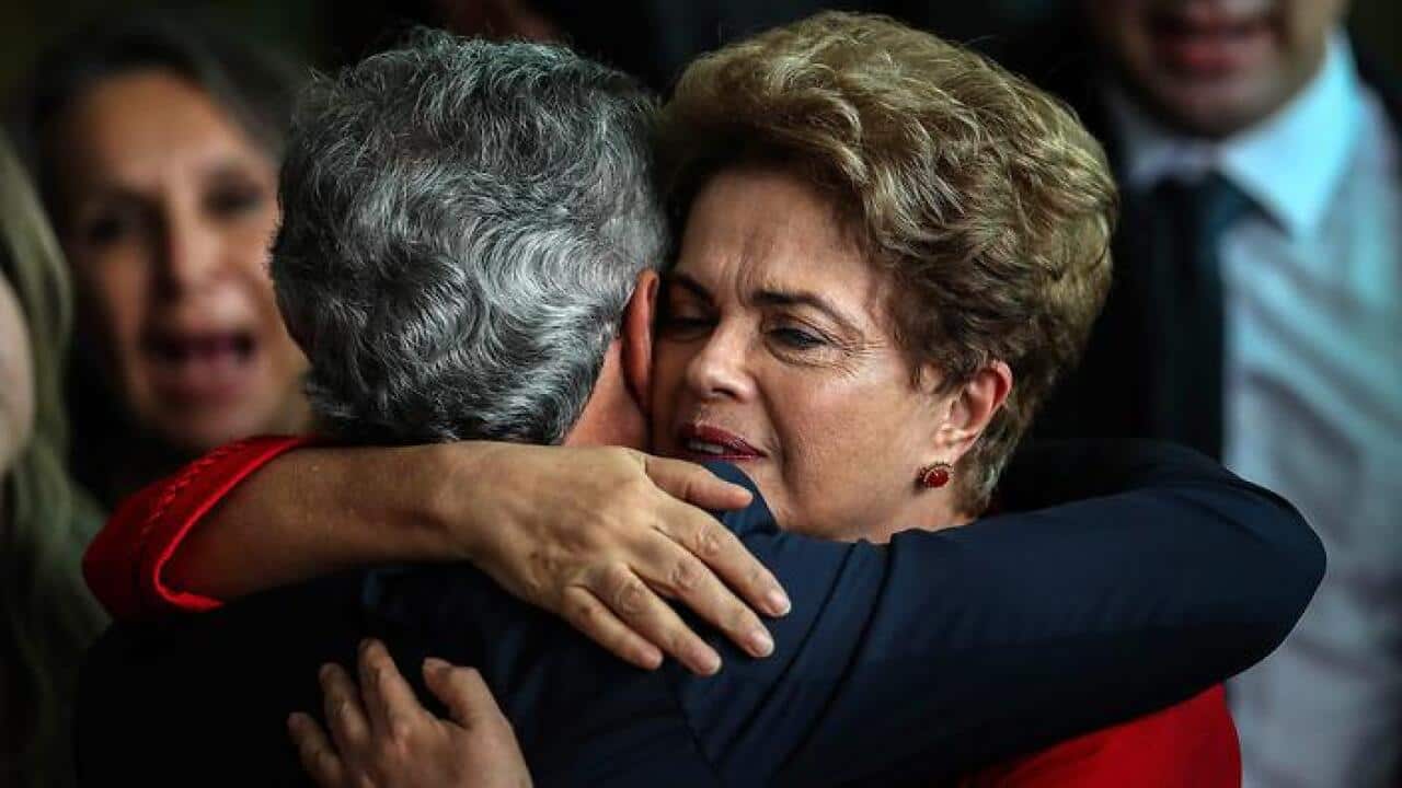 Former Brazilian President, Dilma Rousseff (R) hugs Brazilian senator Jorge Viana after delivering a statement to the press at Alborada Palace (AAP)