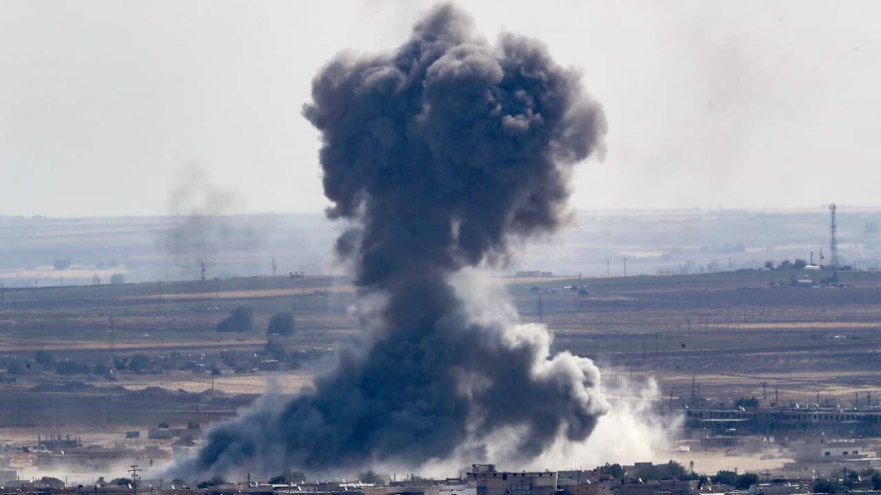 Smoke rises over the Syrian town of Ras al-Ain, as seen from the Turkish border town of Ceylanpinar.