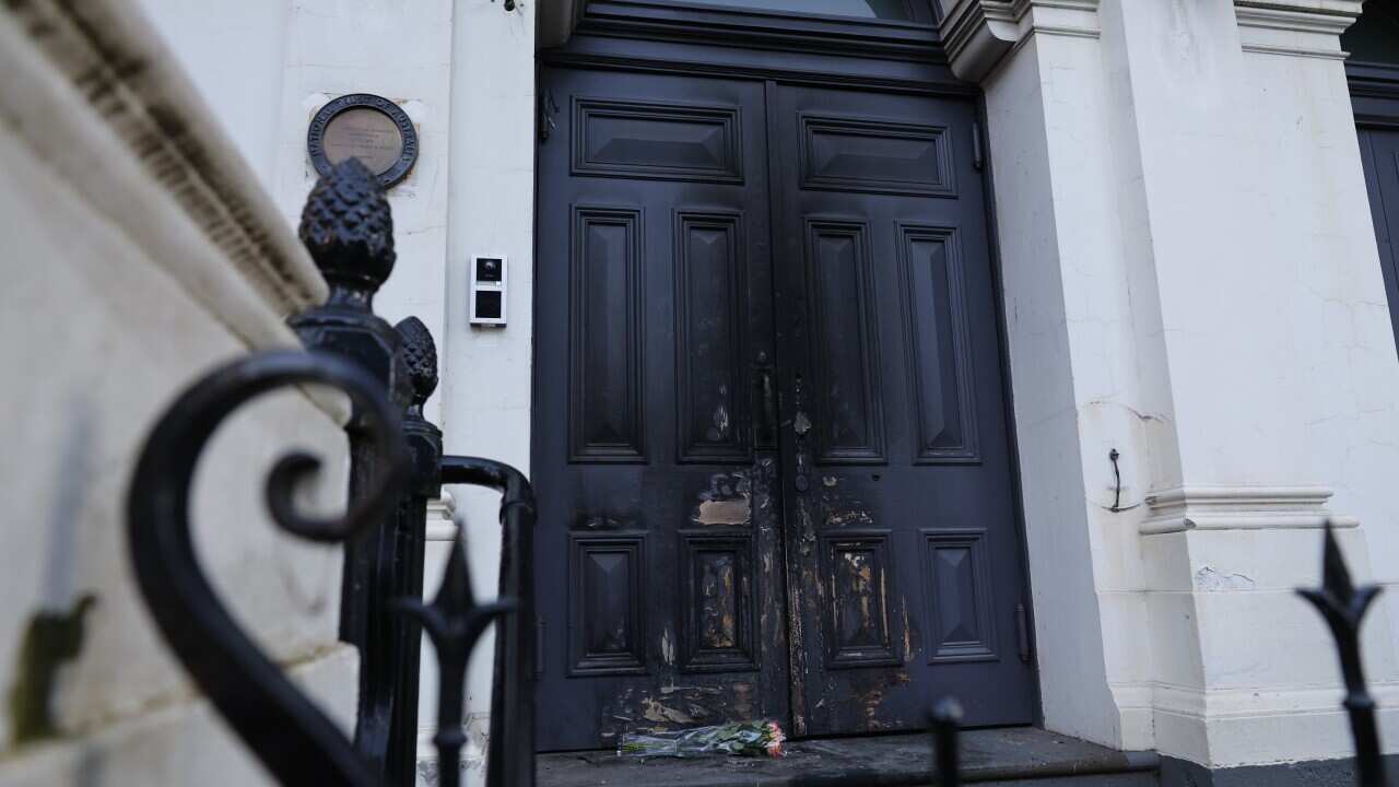 Fire damage is seen on the doors of the East Melbourne Hebrew Congregation (AAP)