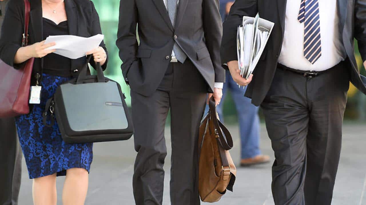 Office workers walk through central Brisbane, Wednesday, May 6, 2015. (AAP Image/Dave Hunt) NO ARCHIVING.