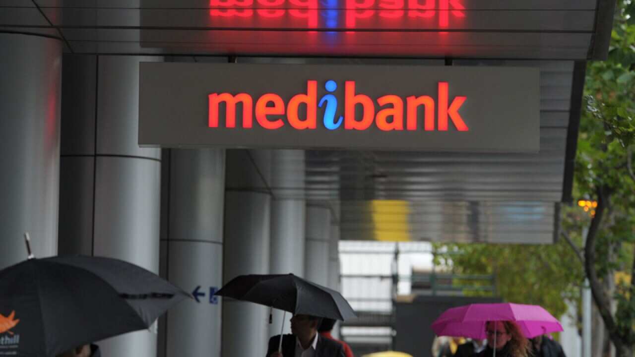 Pedestrians walk past the Medibank Docklands branch in Melbourne